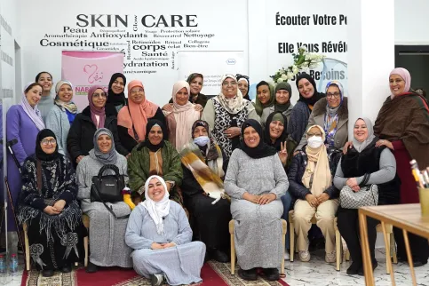 Group of Middle Eastern women smiling, part of a cancer patient organisation